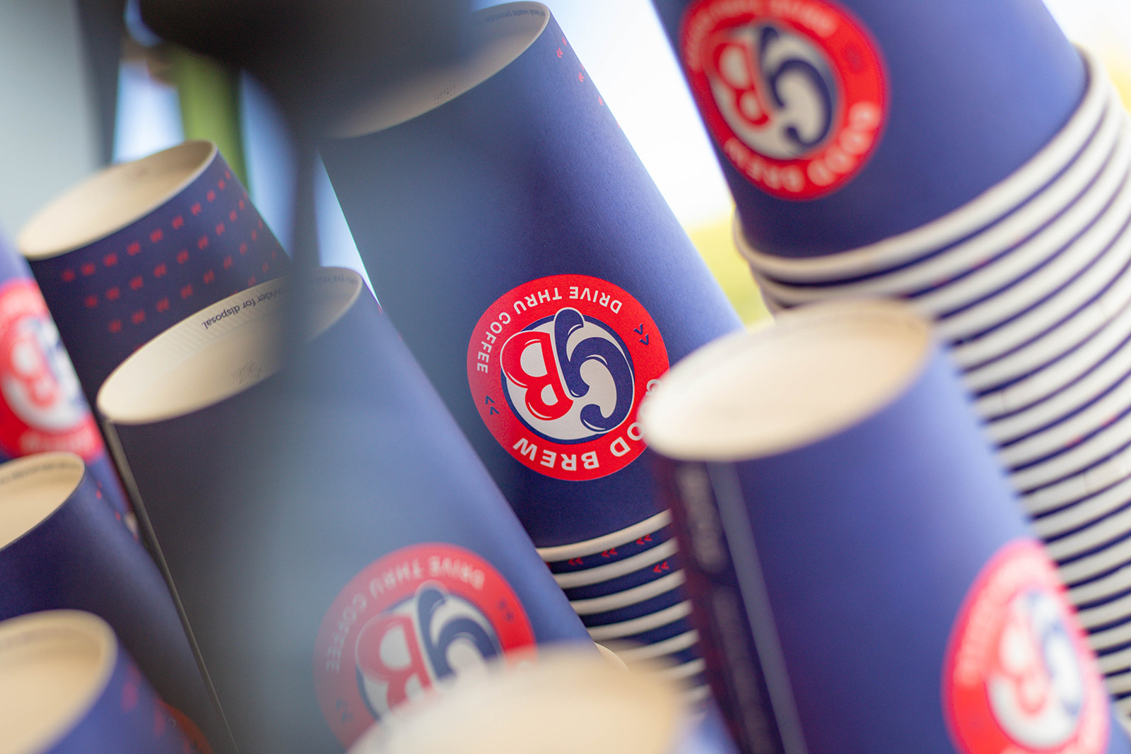 pic of Good Brew Drive Thru coffee cups stacked in piles